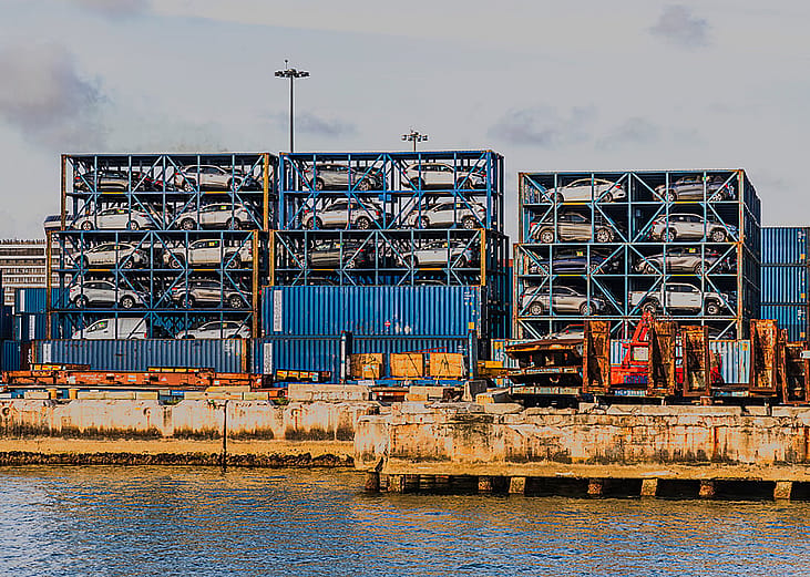 Port Miami with imported cars stacked in metal containers.