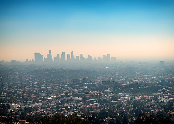 A foggy view of the downtown skyscraper buildings and suburbs of Los Angeles from Griffith Park in California.