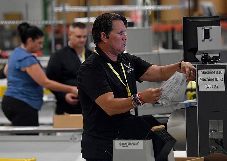 Election workers scan ballots at the scanning stations of the Philadelphia City Commissioners Office and Election Warehouse on Election Day in Philadelphia, Pennsylvania, November 5, 2024.