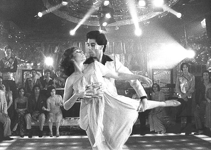 John Travolta dances with Karen Lynn Gorney in a scene from Saturday Night Fever, directed by John Badham.