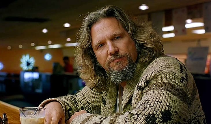 Jeff Bridges as The Big Lebowski sitting in the bowling alley
