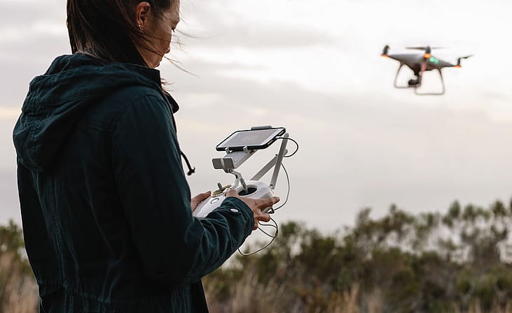 Woman operating a drone