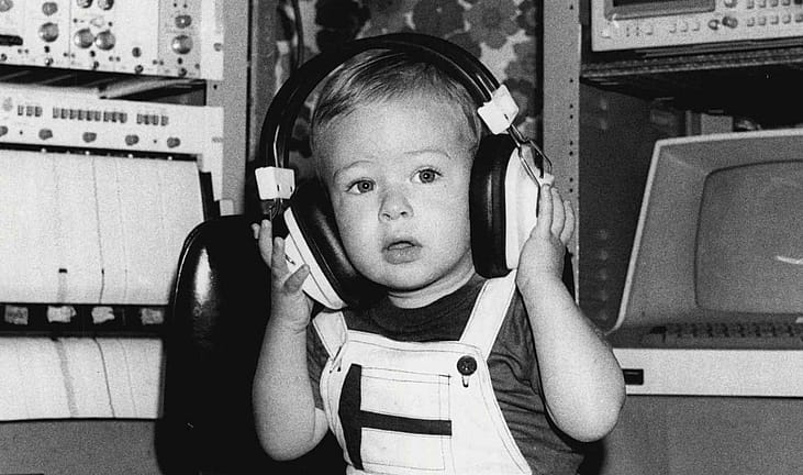 Baby in wearing headphones during an auditory test.