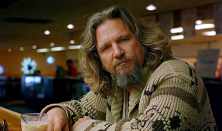Jeff Bridges as The Big Lebowski sitting in the bowling alley