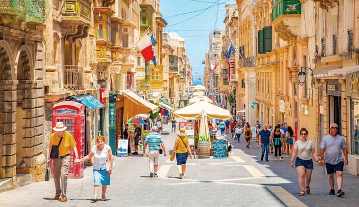 Tourists walk through the streets of Malta on a hot summer day in 2025.