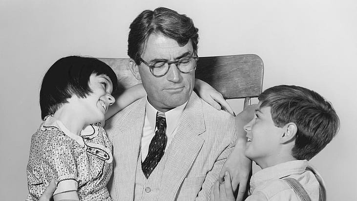 American actors Mary Badham (as Scout), Gregory Peck (as Atticus Finch), and Phillip Alford (as Jem) in a scene from 'To Kill a Mockingbird', 1962.