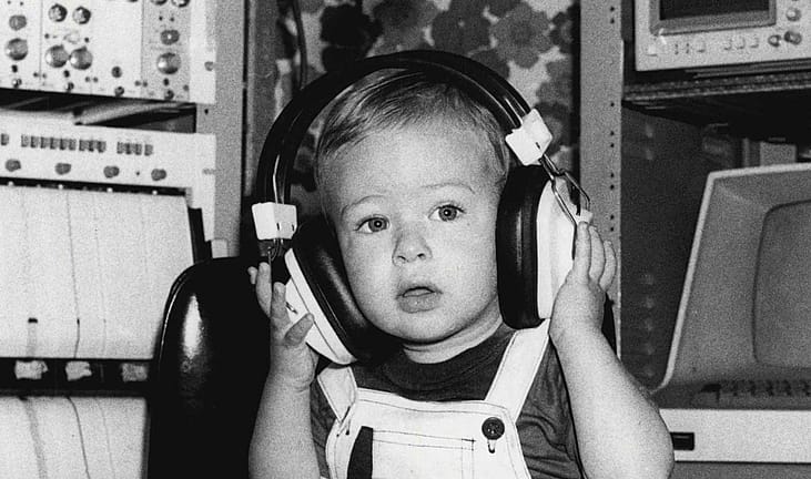 Baby in 1981 wearing headphones during an auditory test.