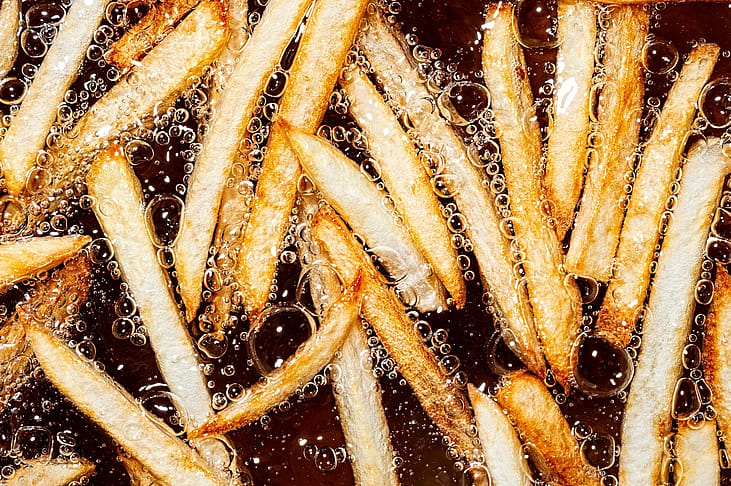 An overhead shot of french fries cooking