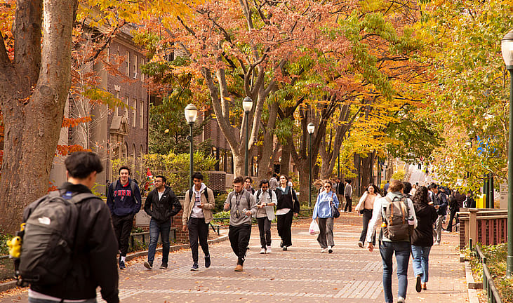 Students walking on campus during the fall