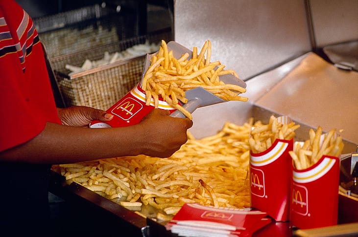A worker in a Chicago, Illinois, McDonald's restaurant prepares a large order of the firm's famous french fries.
