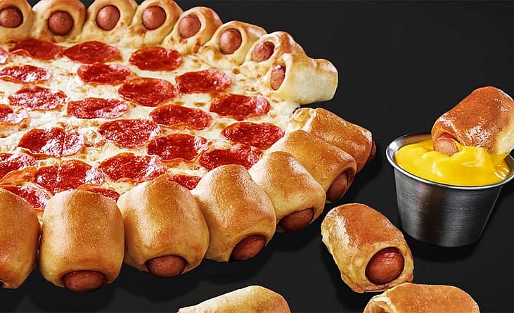 Pepperoni pizza with a crust of mini hot dogs wrapped in dough, served with mustard.