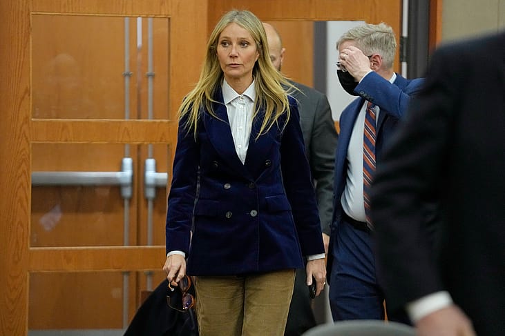 Gwyneth Paltrow entering a courtroom in a blue velvet blazer.