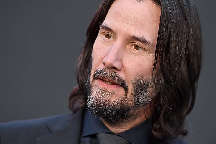 Keanu Reeves in a black suit.