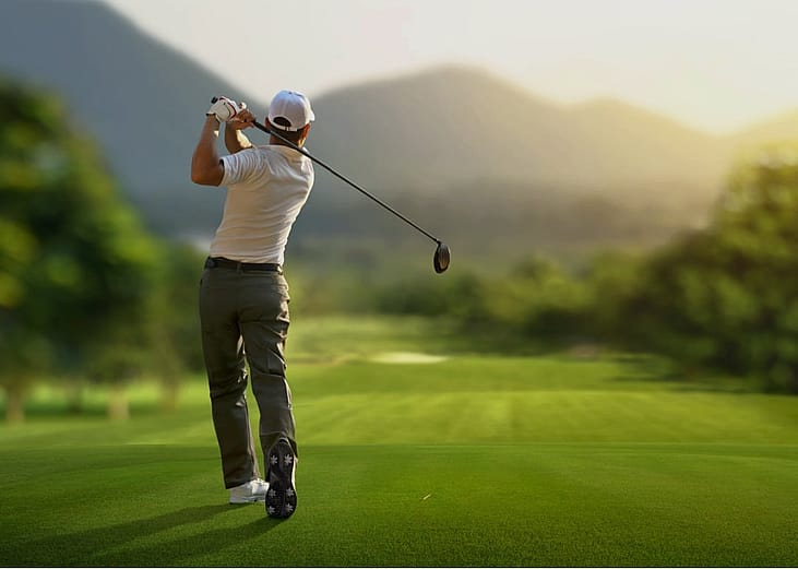 A golfer on a green golf course.