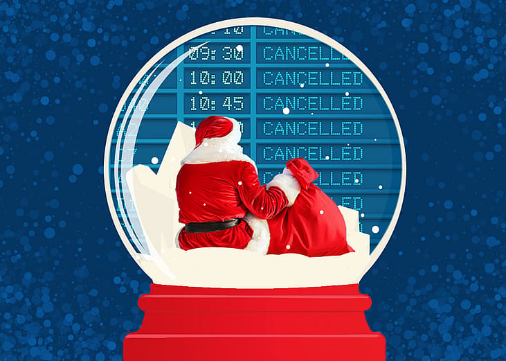 Santa sitting in front of a cancelled flight board inside a snow globe.