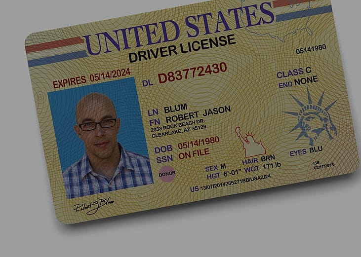 A close-up of the United States driving license with a photo of a man on a yellow background on the left side, his name Robert Jason Blum, expiration date, ID number, address, sex, hair, eyes, height and class.
