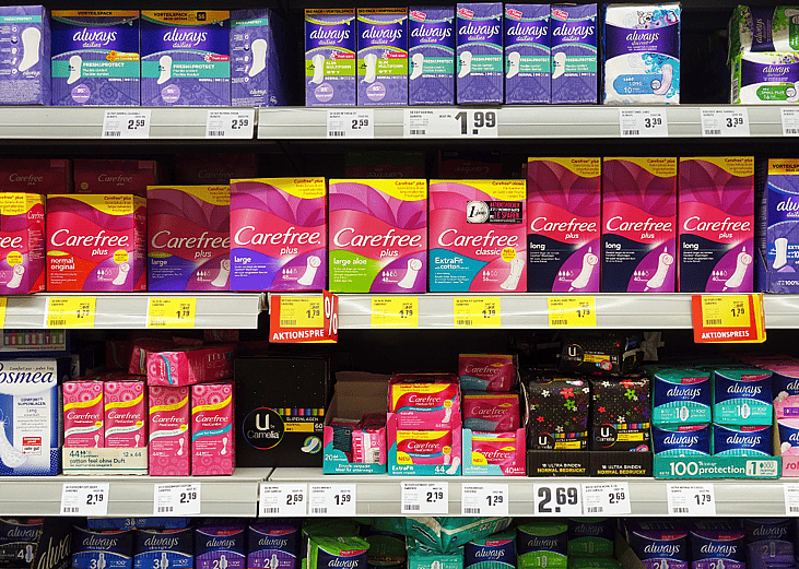 A store shelf displaying feminine products that are subject to the pink tax