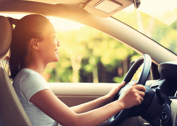 A young person driving a car.