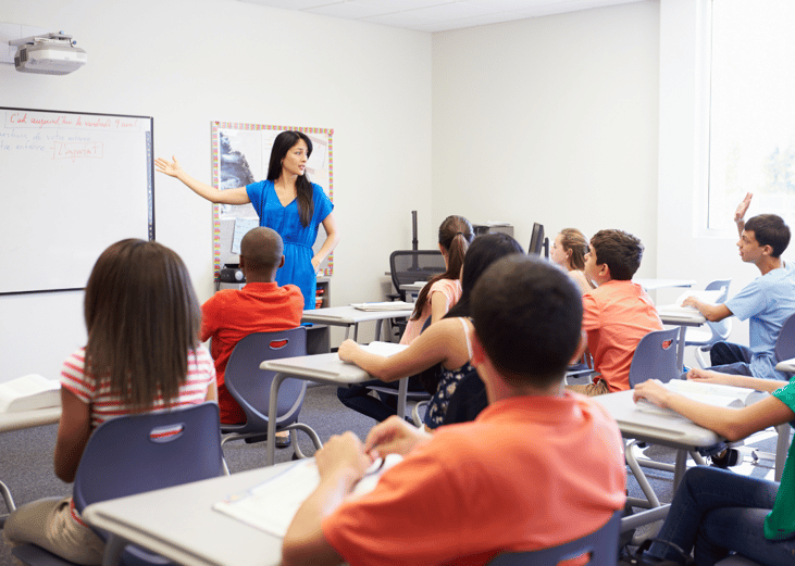 A teacher presenting a lesson to a group of high schoolers.