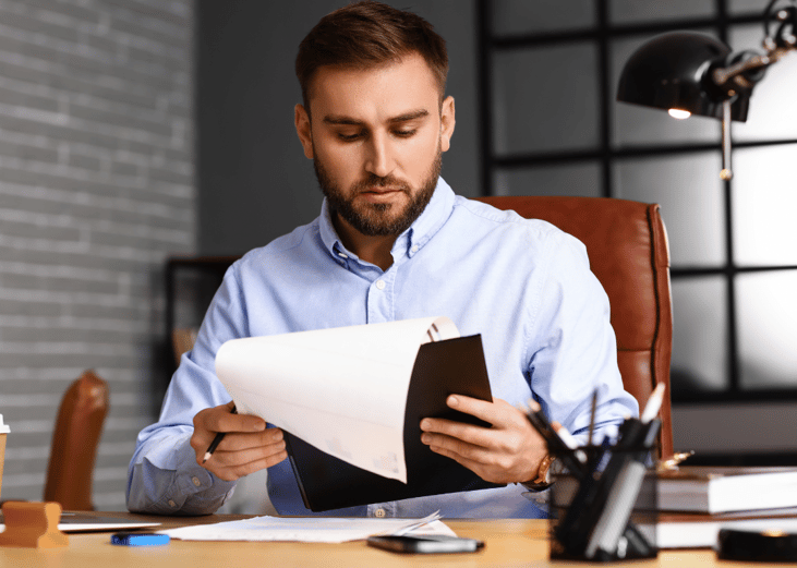 An insurance underwriter reviews a file to determine into which group a new client should be placed. 