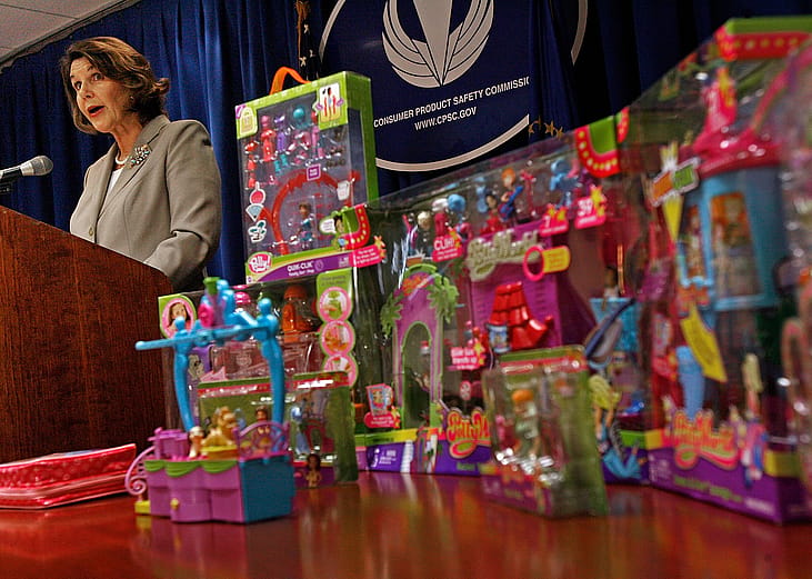 U.S. Consumer Product Safety Commission acting Chariman Nancy Nord announces the recall of millions of toys with many boxes of toys placed on a table next to her podium.