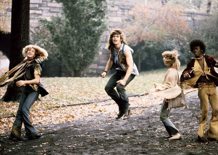 Hippies dancing outside.