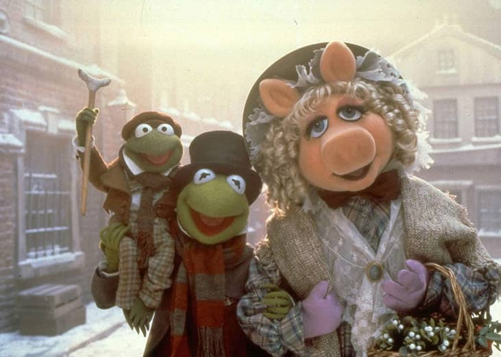 Miss Piggy, Kermit the Frog and a little frog smiling.