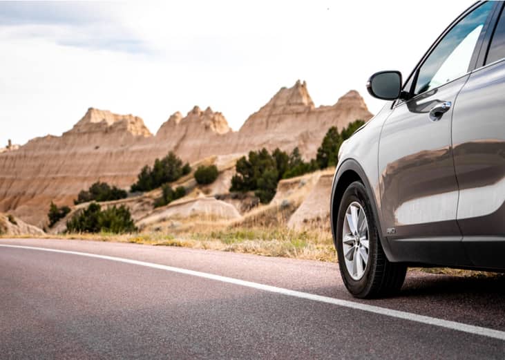 Car parked on road in Badlands.