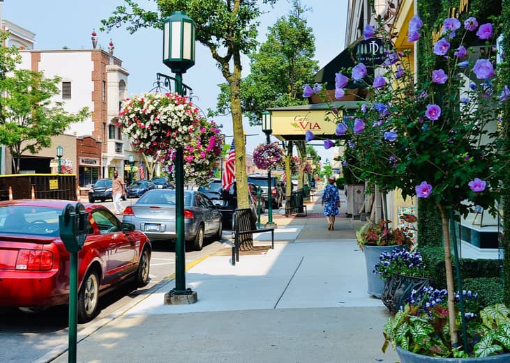 Flower-lined streets of parked cars in Birmingham, Michigan.