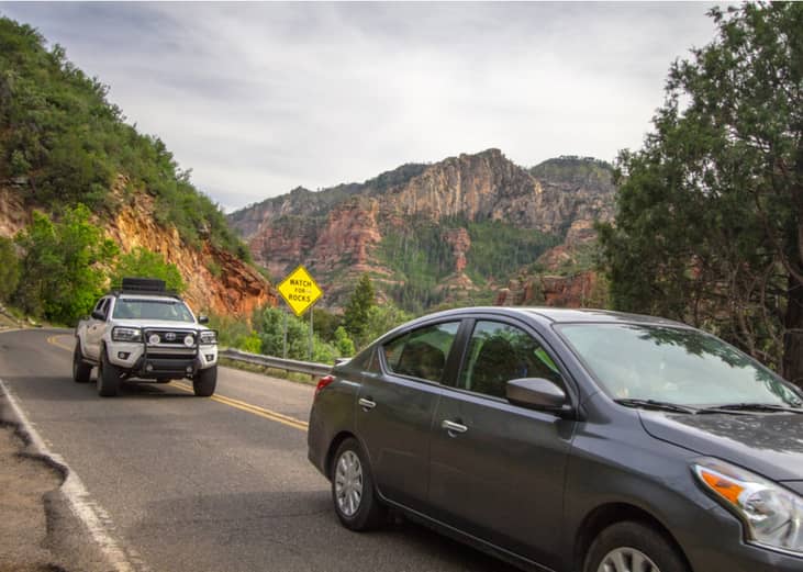 Truck and car driving on winding mountain road near Sedona, Arizona.