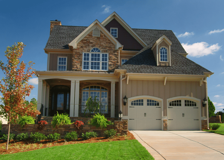 A stone home with two-car garage.