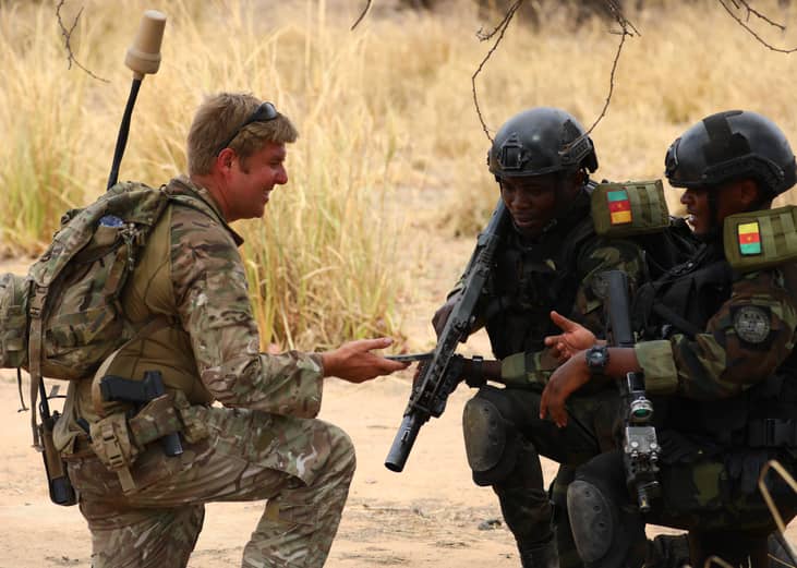 Cameroonian soldiers interact with a US soldier (L) as they take part in a counter-terrorism training session.