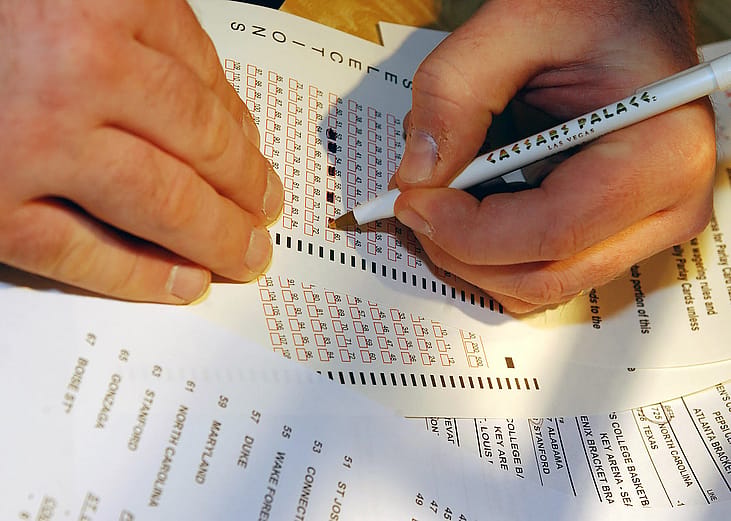 Sports bettor marks their selections on a Parlay Card at Caesars Palace.