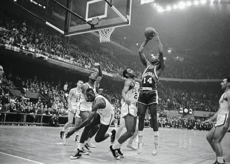 Black-and-white, wide shot of Oscar Robertson shooting a ball during a game against the Celtics