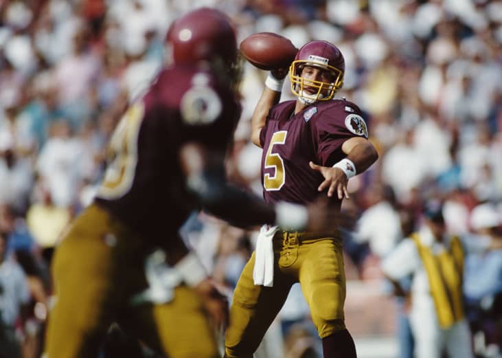 Heath Shuler for the Washington Redskins prepares to pass the ball to Tight End Ethan Horton.