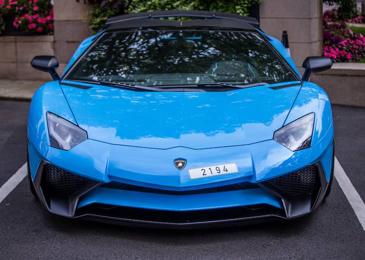 A baby blue Lamborghini Aventador SV Roadster.