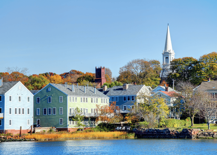 Pastel blue and green buildings on the water in New Haven, Connecticut.