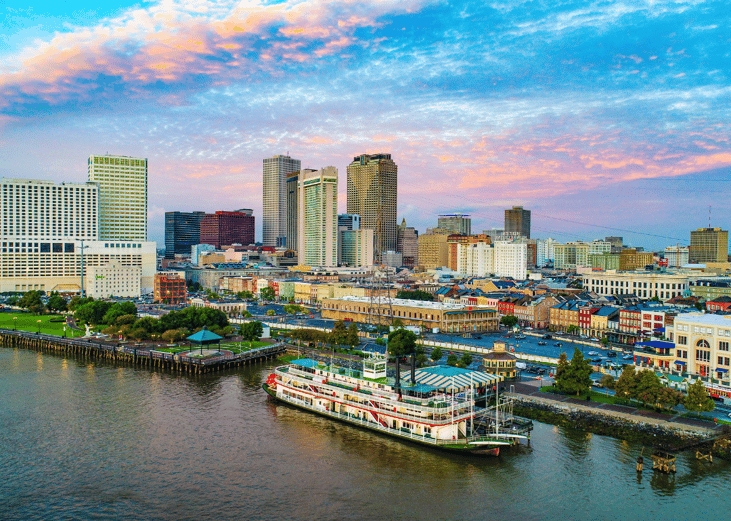Boats on the water in New Orleans, Louisiana and downtown in the background.