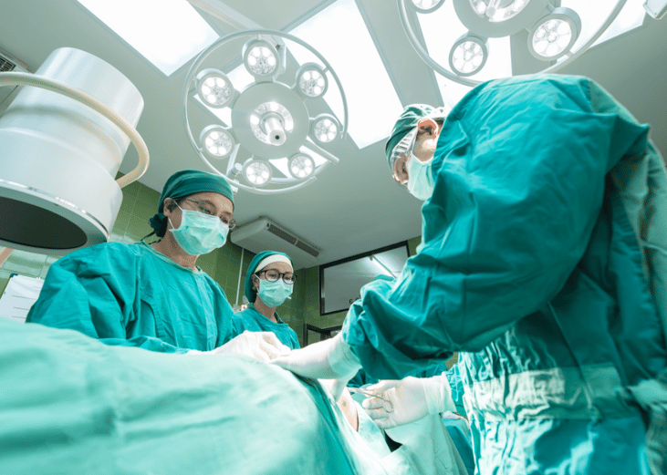 Surgery team dressed in green scrubs.