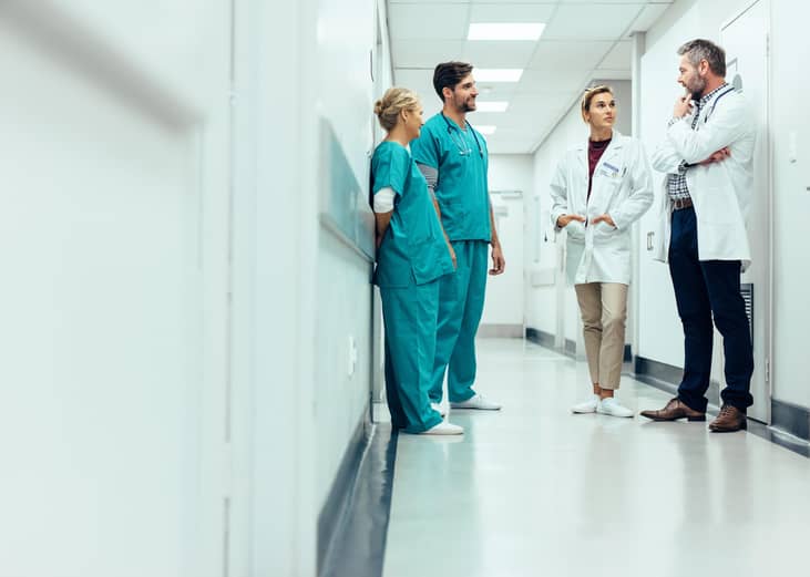 Doctors and nurses talking in the hall.