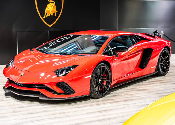 Front side view of a Rosso Mars red Lamborghini Aventador S LP740-4 Coupe.