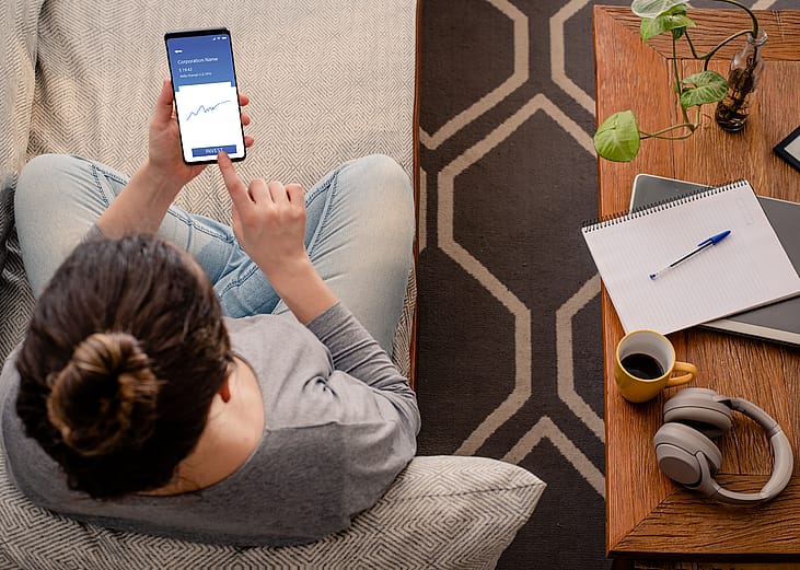 Woman using investment mobile app.