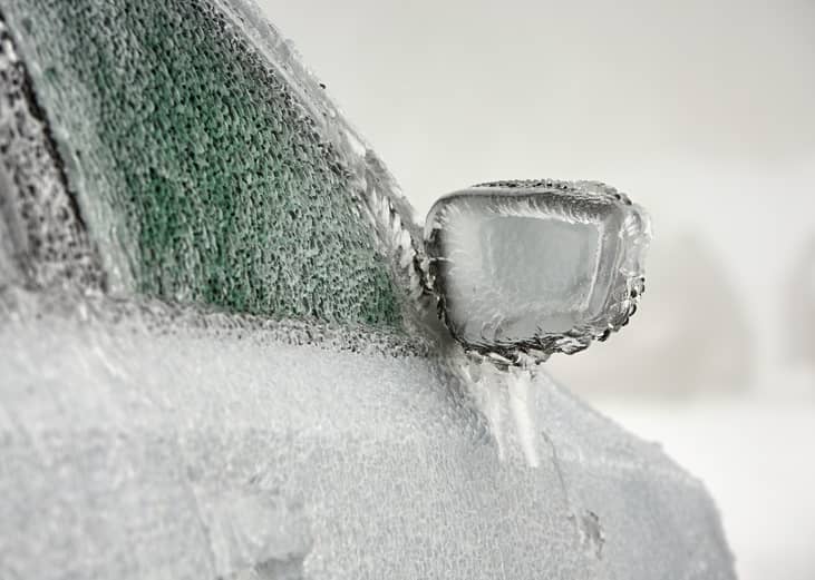 Car on the street covered by icy rain.