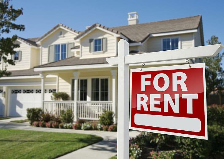 Red For Rent sign in front of a house.