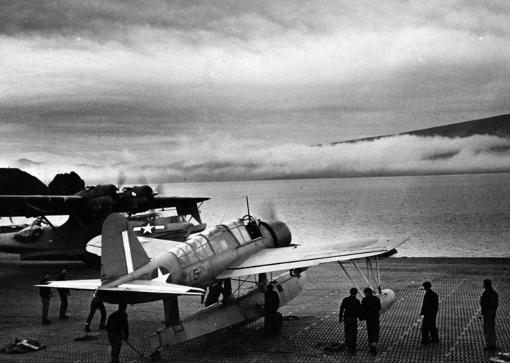 Pictured: Vought OS2U Kingfisher is launched from repair mat at Attu, Aleutian Islands, 1943