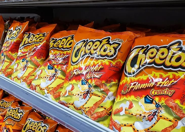 Several bags of Flamin' Hot Cheetos at the grocery store.