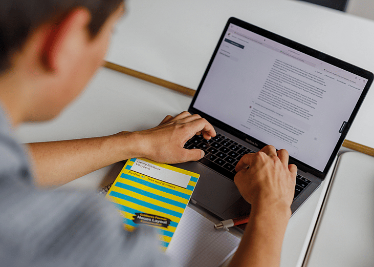 A closeup of student's hands typing on the computer keyboard.