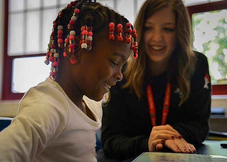 Americorps reading tutor Kelly Meany, L, gives one-on-one reading instructions to 7-year-old 2nd grader Madissen Moody at C.W. Harris Elementary School in D.C where Corps members play a huge role in DC public schools, teaching kids to read and acting as role models, on Friday, September 19, 2014