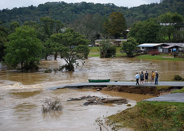 Residents that canoed the flooded South Fork New River talk at a washed out road on September 27, 2024 in Boone, North Carolina