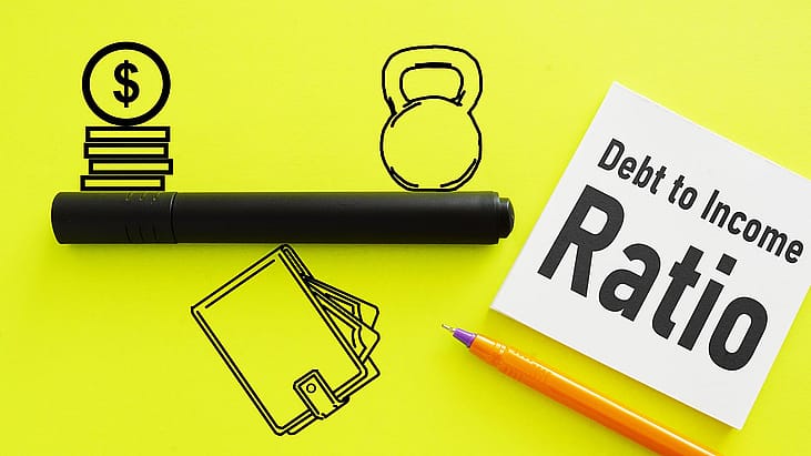 Icons representing money and debt on opposite sides of a line, balancing on a wallet symbolizing income on a flourescent yellow background, with a white post it saying "Debt to Income Ratio."